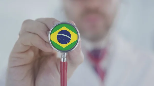 Doctor uses stethoscope with the Brazilian flag. Healthcare in Brazil — Stock Photo, Image
