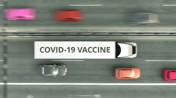 Vue aérienne du haut vers le bas du camion semi-remorque qui livre le vaccin contre le coronavirus COVID-19. rendu 3D — Photo