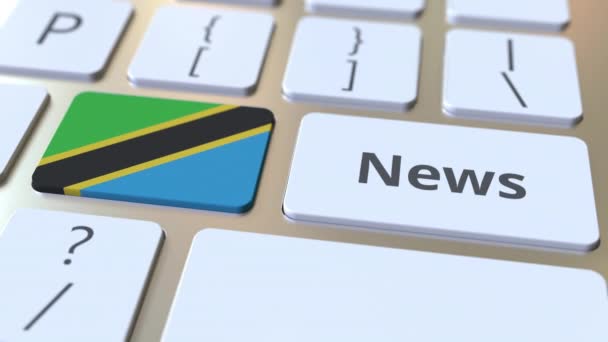 Nyheter text och flagga Tanzania på tangenterna till ett datortangentbord. Nationella online media relaterade konceptuell 3D-animering — Stockvideo