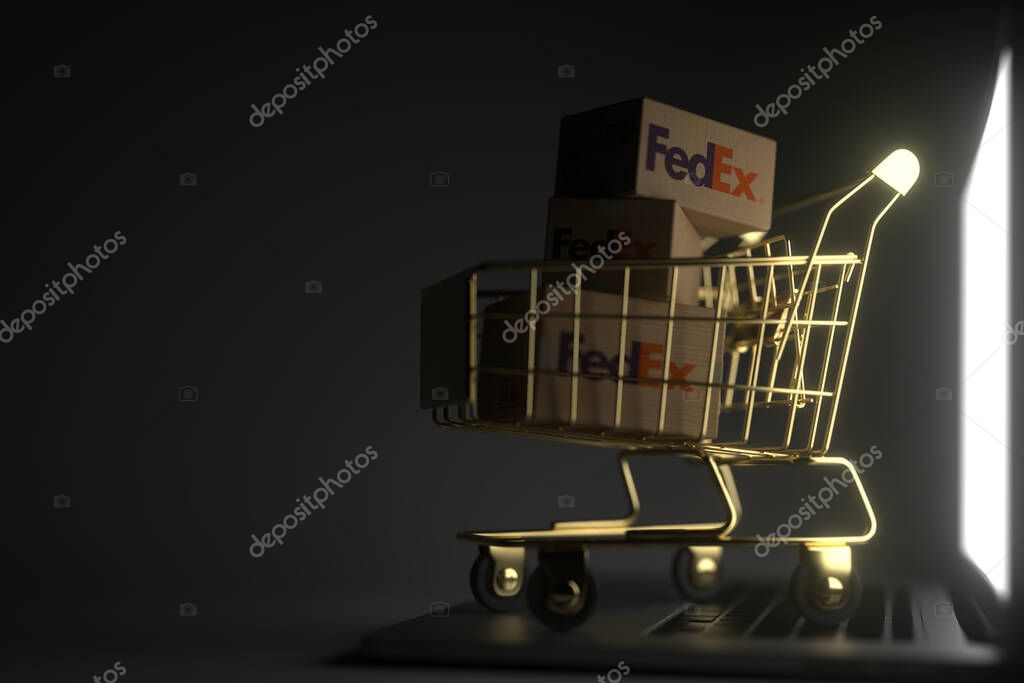 Boxes in shopping cart on the laptop keyboard. Editorial 3D