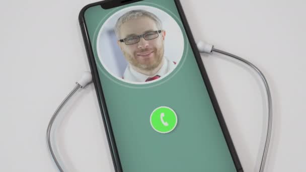 Doctors call on smartphone with attached stethoscope. Telemedicine or modern safe remote medical care services related conceptual clip — Stock Video