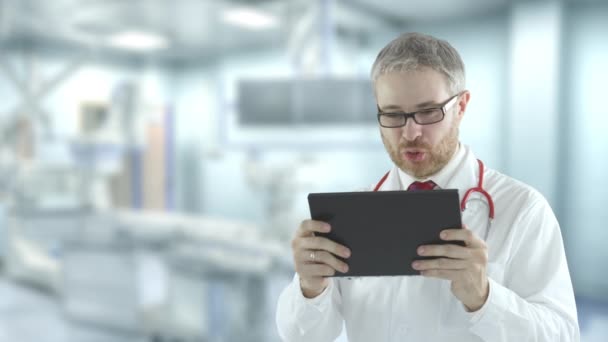 Arzt nutzt seinen Tablet-PC für telemedizinischen Anruf. Schuss auf rote Kamera — Stockvideo