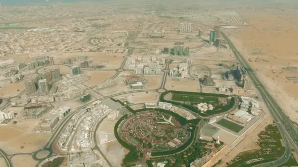 Aerial view of the Dubai Miracle Garden within cityscape. United Arab Emirates — Stock Video