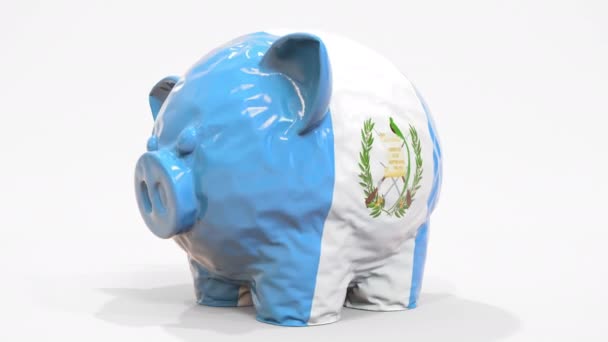 Deflating inflatable piggy bank with printed flag of Guatemala. Guatemalan financial crisis related conceptual 3D animation — Stock Video