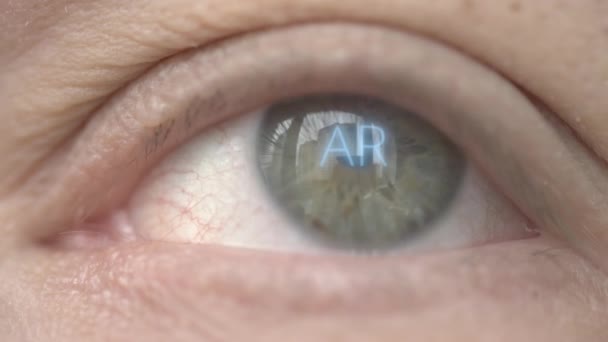 AR or Augmented Reality text on human eye. Modern technology related macro shot — Stock Video
