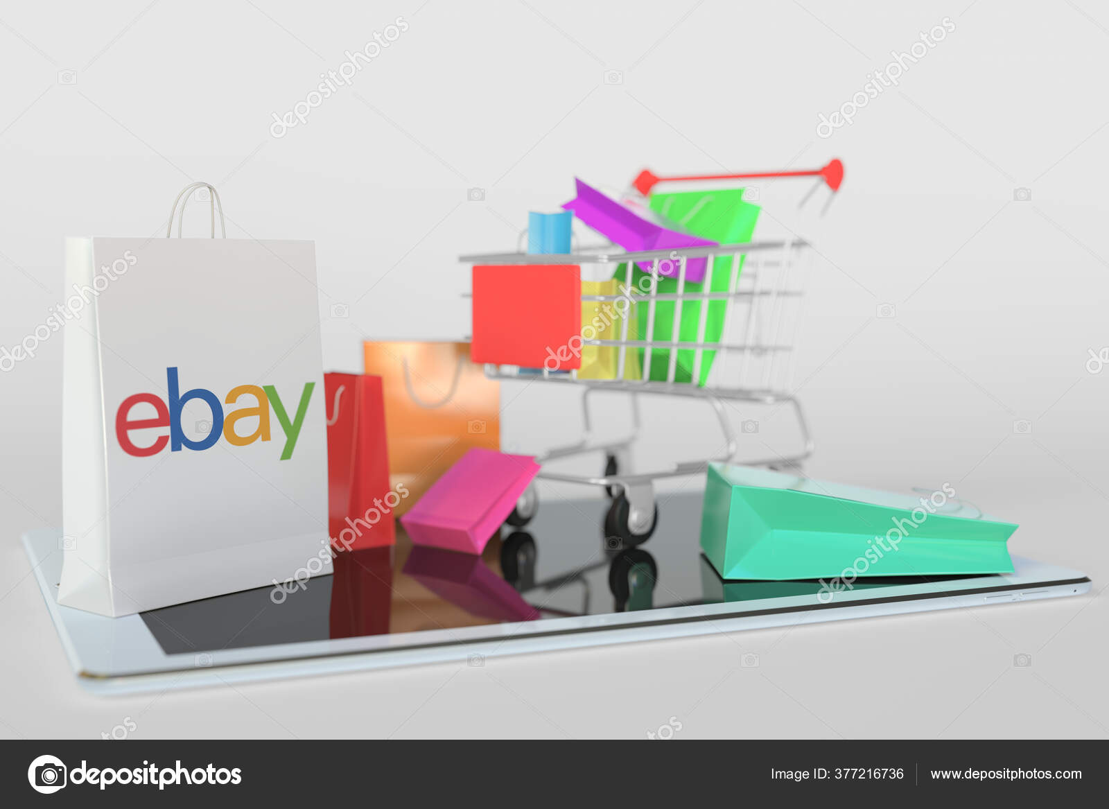 Shopping cart on a tablet computer and paper bag with  logo