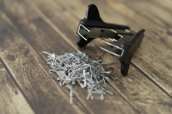 Staple pin remover with pile of staple pins