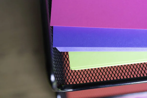 Stack of documents on brightly colored paper on stacked tray on office table — Stock Photo, Image