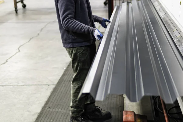 Corrugated roofing metal sheets produced in a factory