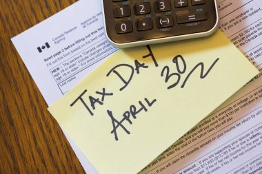 Canada Tax Day April 30 - Canadian tax forms with calculator and sticky note clipart
