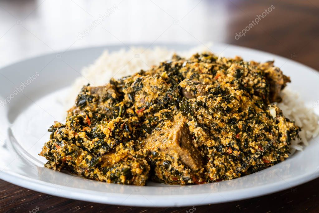 Nigerian Egusi Melon soup served with white rice at restaurant
