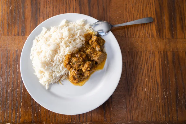 Weißer gekochter Reis mit würzigem Ofada-Eintopf, eine traditionelle nigerianische Mahlzeit — Stockfoto