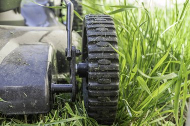 Bahçedeki çim biçme makinesinde çim biçmek için tekerlekler