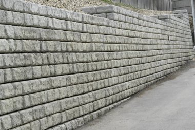 Retaining wall in residential area to protect against erosion clipart