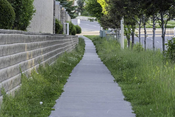 Sentier pédestre le long d'un mur de soutènement dans un quartier résidentiel — Photo