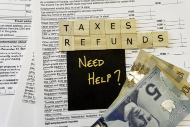 New Canadian personal tax forms and letter tiles showing refunds and taxes clipart