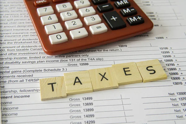 New Updated Tax Canadian Tax Forms with letter tiles spelling - Taxes — Stockfoto
