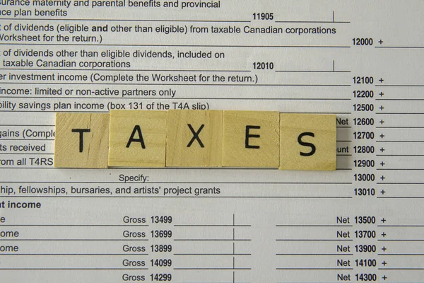 New Updated Tax Canadian Tax Forms with letter tiles spelling - Taxes