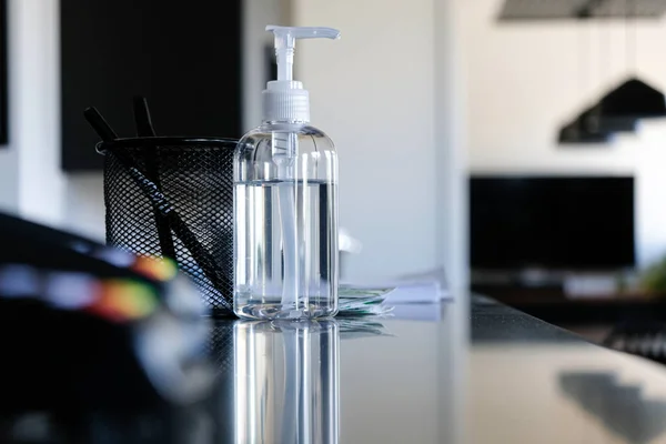 Bottle of Hand sanitizer on office reception counter to help clean hands