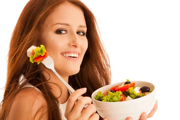 Healthy eating  - woman eats a bowl of greek salad isolated over — Stock Photo, Image