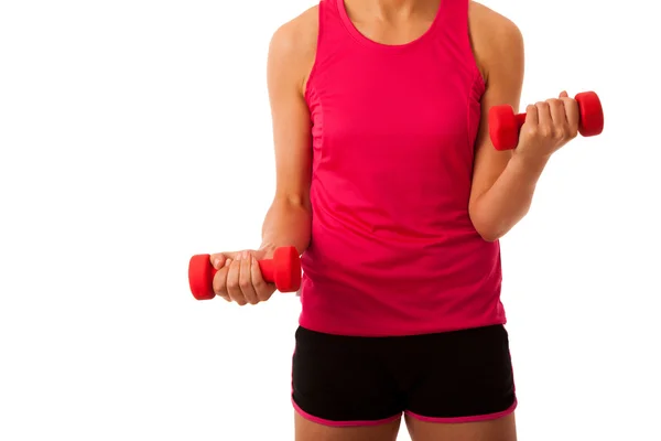 Active young woman workout with dumbbells in fitness gym isolate — Stock Photo, Image