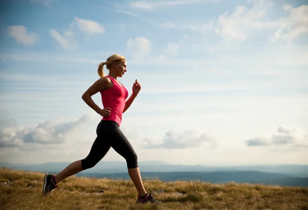 Runner - woman runs cros country on a path in early autumn — Stock Photo, Image