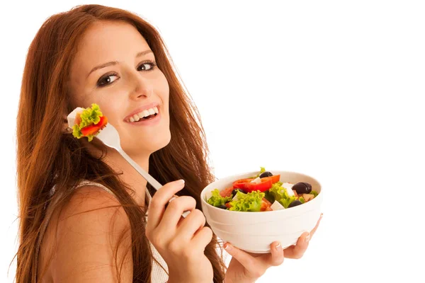 Healthy eating  - woman eats a bowl of greek salad isolated over — Stock Photo, Image