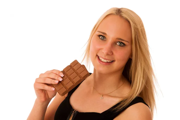 Beautiful young woman eats chocolate isolated over white backgro — Stock Photo, Image