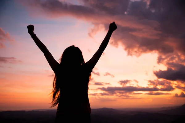 Woman gesturing success - silhouette over evening sky — Stock Photo, Image