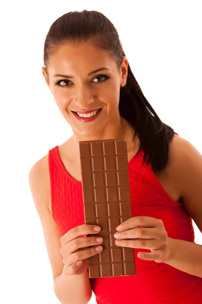 Beautiful young woman eats chocolate isolated over white backgro — Stock Photo, Image
