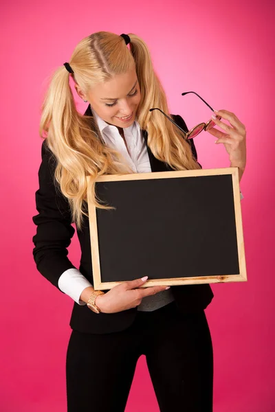 Funky business woman holding a blank blackboard - teacher — Stock Photo, Image
