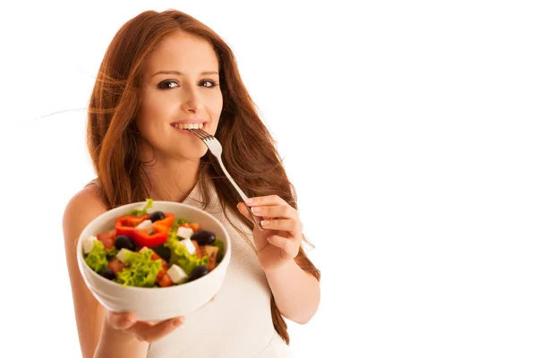 Healthy eating  - woman eats a bowl of greek salad isolated over — Stock Photo, Image