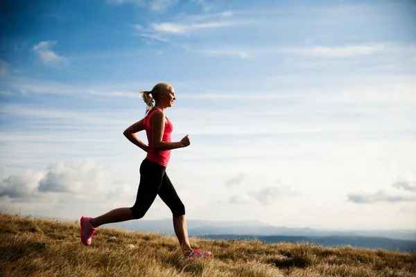 Runner - woman runs cros country on a path in early autumn — Stock Photo, Image