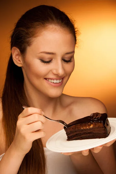 Čokoládový dort - okouzlující žena jí moučník — Stock fotografie