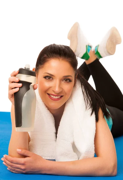 Woman rests after fitness workout with towel around her neck dri — Stock Photo, Image