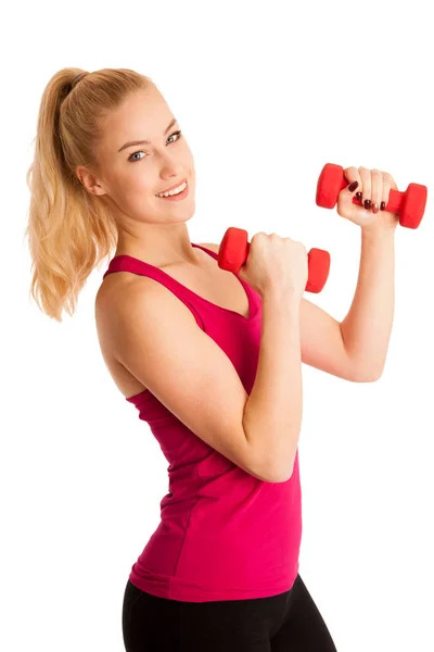 Linda joven rubia haciendo ejercicio en el gimnasio de fitness aislado sobre —  Fotos de Stock