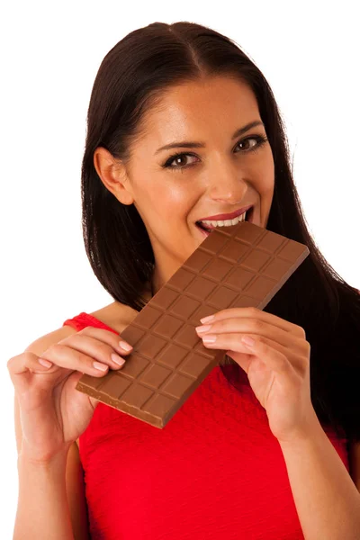 Beautiful young woman eats chocolate isolated over white backgro — Stock Photo, Image