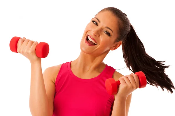 活跃的年轻女人锻炼与哑铃在健身房孤立在白色的背景 — 图库照片