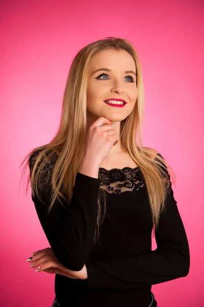 Portrait of a beautiful teenage girl over pink background — Stock Photo, Image