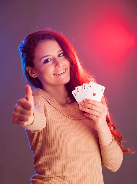 Beautiful brunette holding four aces as a sign for poker game, g — Stock Photo, Image