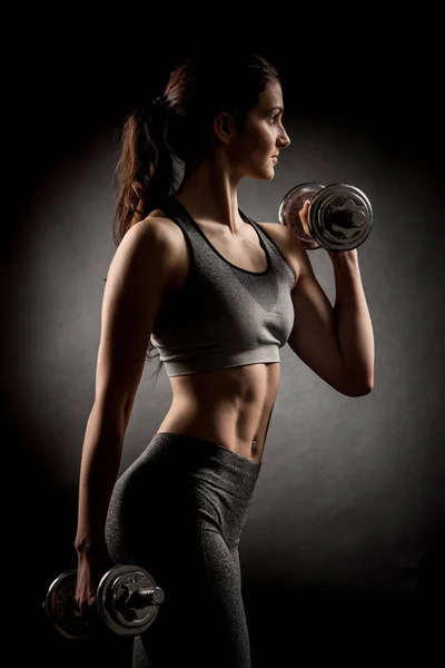 Atractive fit woman works out with dumbbells as a fitness concep — Stock Photo, Image