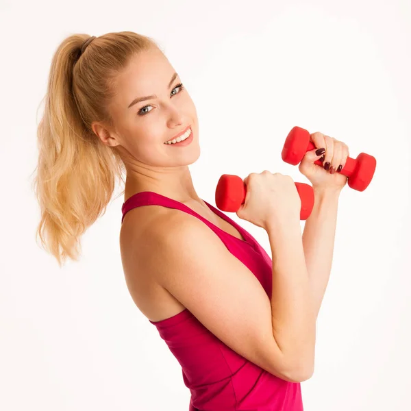 Cute young blond woman working out in fitness gym isolated over — Stock Photo, Image