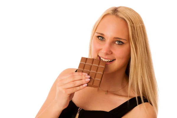 Beautiful young woman eats chocolate isolated over white backgro — Stock Photo, Image