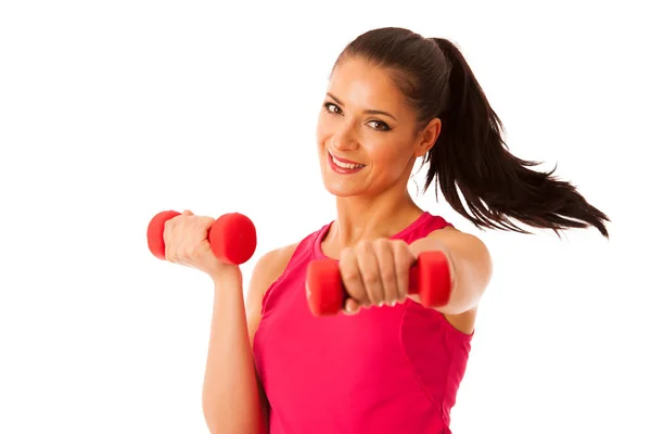 Entrenamiento activo de mujer joven con pesas en gimnasio de fitness aislado —  Fotos de Stock