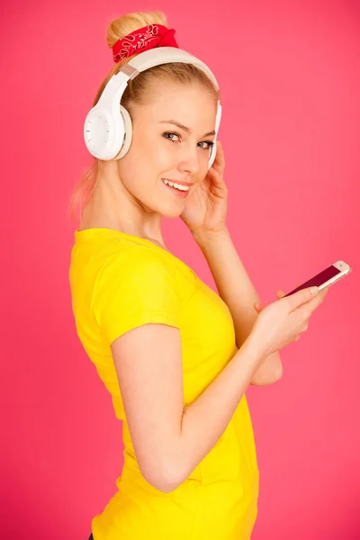 Hermosa joven con grandes auriculares escucha la música o —  Fotos de Stock