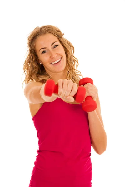 Linda joven rubia haciendo ejercicio en el gimnasio de fitness aislado sobre — Foto de Stock