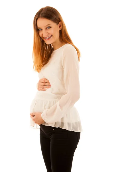 Vackra gravid kvinna som håller magen isolerade över vita backg — Stockfoto