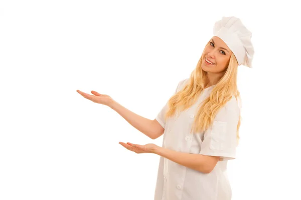 Young blonde chef points to copy space as she presents a new rec — Stock Photo, Image