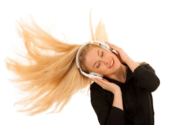 Hermosa joven mujer escucha la música en los auriculares y dan —  Fotos de Stock