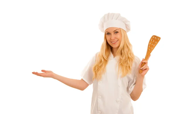 Young blonde chef points to copy space as she presents a new rec — Stock Photo, Image